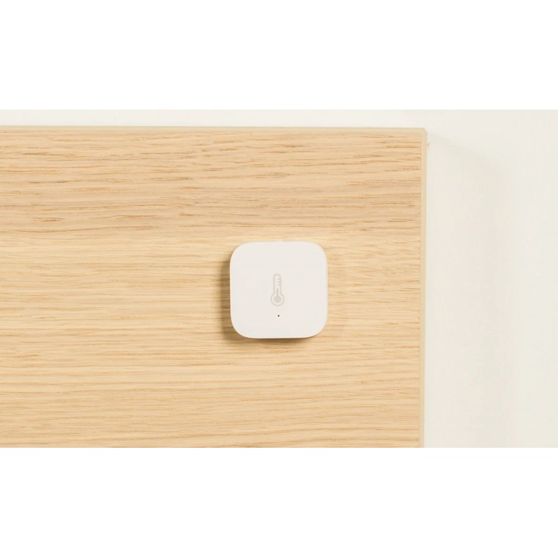 Czujnik temperatury i wilgotności Aqara T1 (TH-S02D) na drewnianej desce - biały, kwadratowy design.